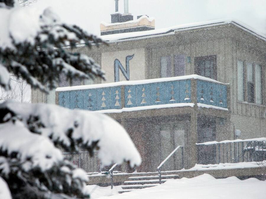A building with a prominent 'N' on the facade, surrounded by snow.