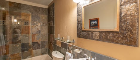 A bathroom with a bathtub, toilet, and sink.