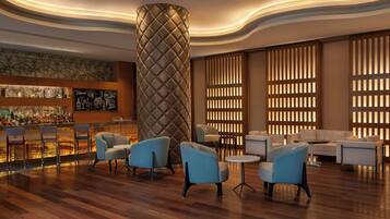 A modern lobby with a bar area, seating, and decorative panels.