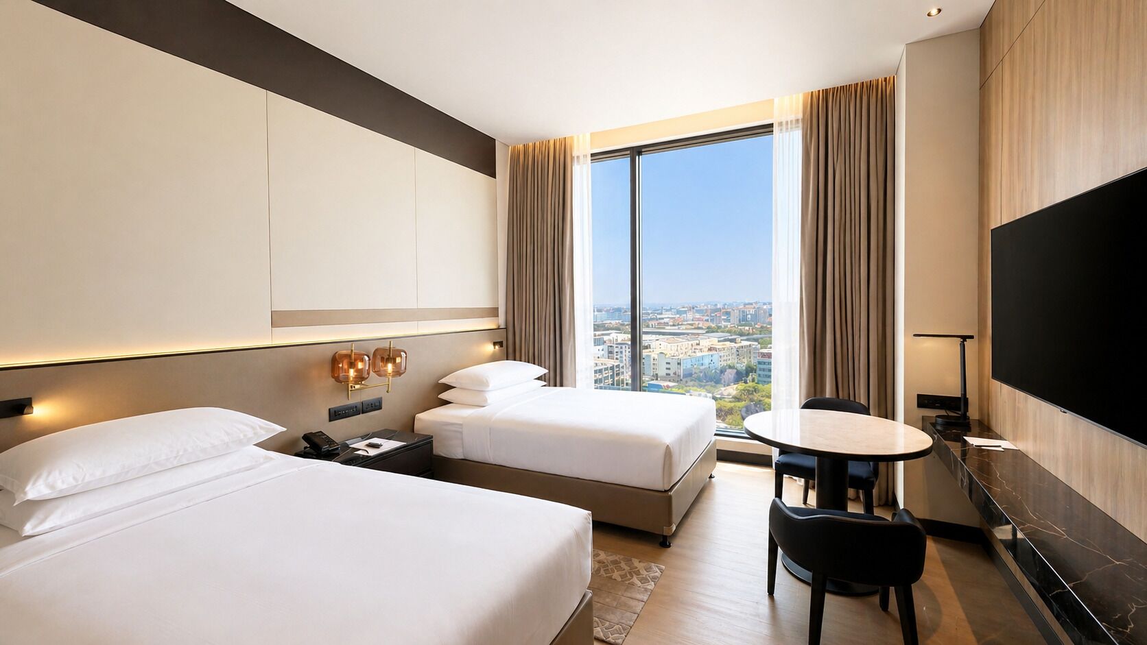 A hotel room with two beds, a desk, a chair, a TV, and a large window with a city view.