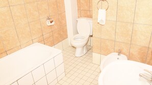 Ein Badezimmer mit Toilette, Waschbecken und Badewanne.