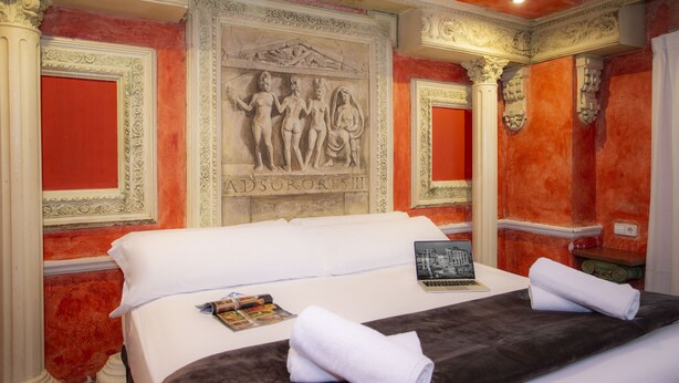 A hotel room with a bed, a laptop, and a magazine on the bed. - Casual de las Civilizaciones Valencia by Casual Hoteles (Valencia)