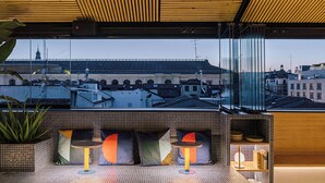 A modern interior with a seating area featuring a view of the cityscape.
