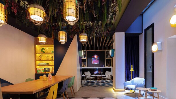 A modern interior with a dining area, seating, and a bar.