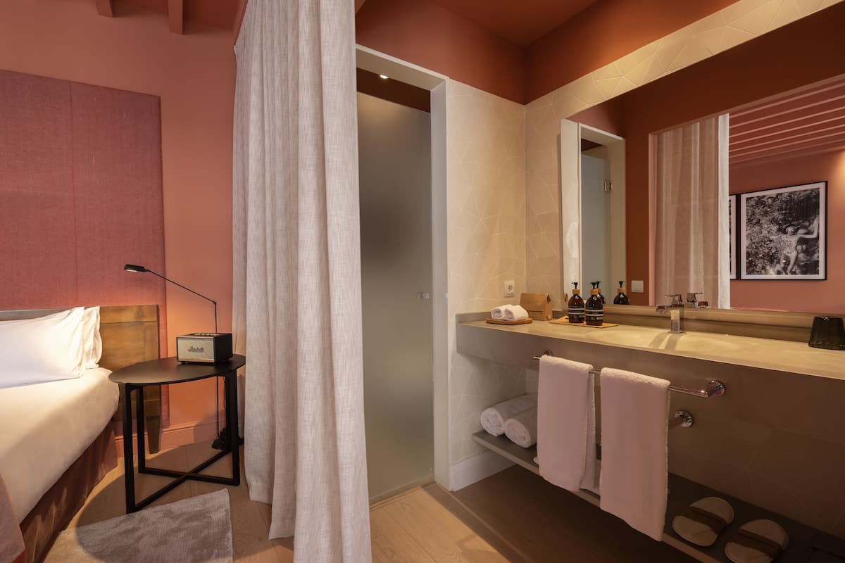 deluxe double room | bathroom | rainfall showerhead, designer toiletries, hair dryer, bathrobes
