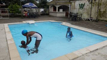 Guests can enjoy a refreshing swim in the pool surrounded by a deck with seating areas.