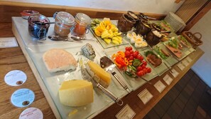 A buffet with various food items including fruits, vegetables, and desserts.