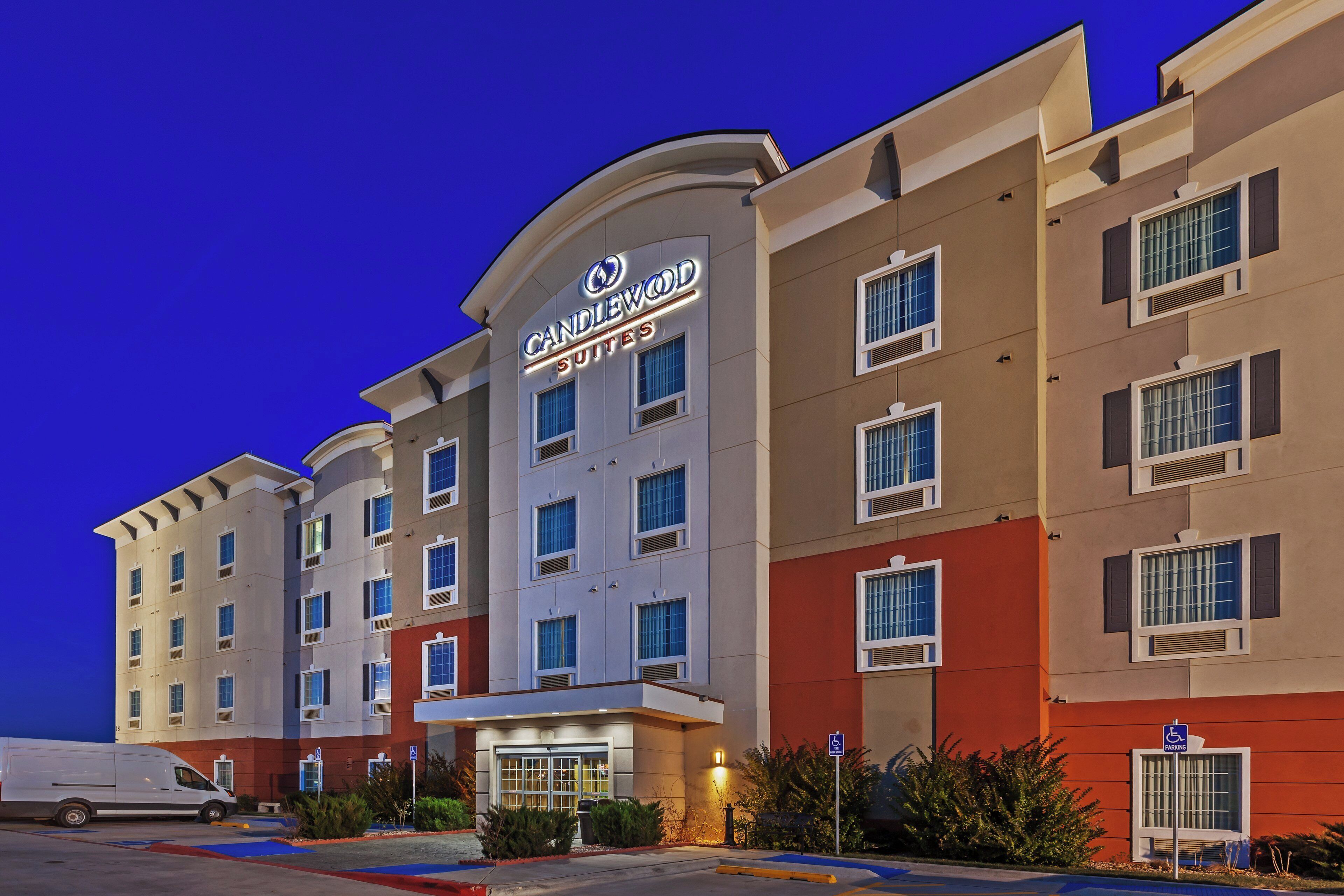 A hotel with a modern facade, multiple windows, and a sign indicating it is a hotel.