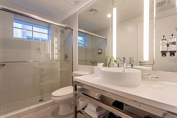 Combined shower/tub, designer toiletries, hair dryer, towels at Pestana South Beach Art Deco Miami