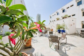 Enjoy dining or socializing in this outdoor patio area with a round table and comfortable seating.