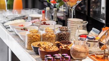 A buffet with various food items and condiments.
