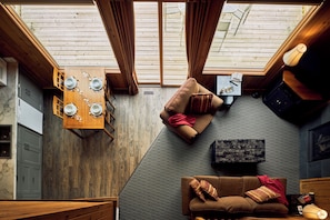 Deluxe Cabin | Living area | Flat-screen TV, fireplace, DVD player, table tennis - Banff Gate Mountain Resort (Canmore)