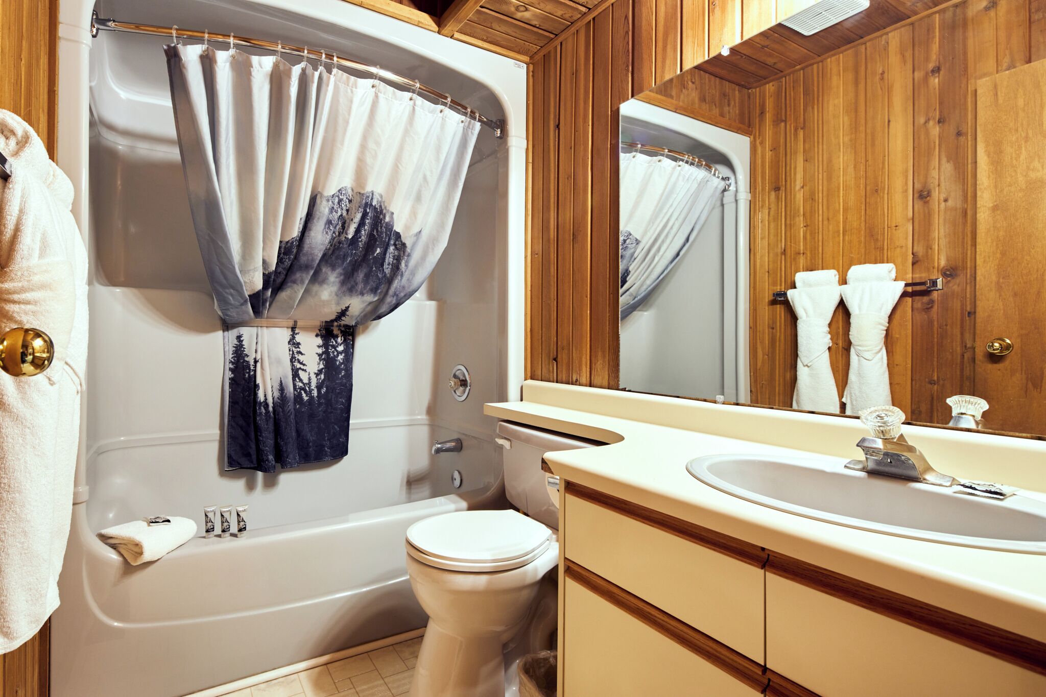 A bathroom with a bathtub, toilet, and sink.
