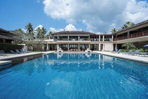 A large swimming pool with lounge chairs and a building with multiple balconies. - Southsea Khaolak Beach Resort (Takua Pa)