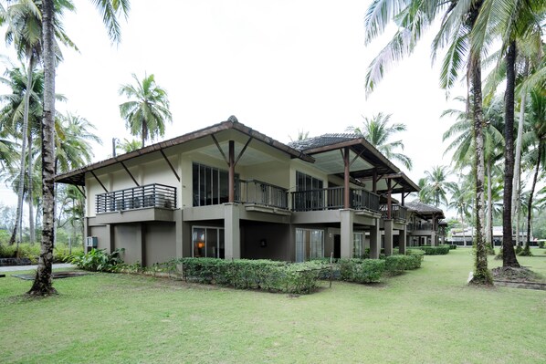 A two-story building with balconies, surrounded by palm trees and a well-maintained lawn. - Southsea Khaolak Beach Resort (Takua Pa)