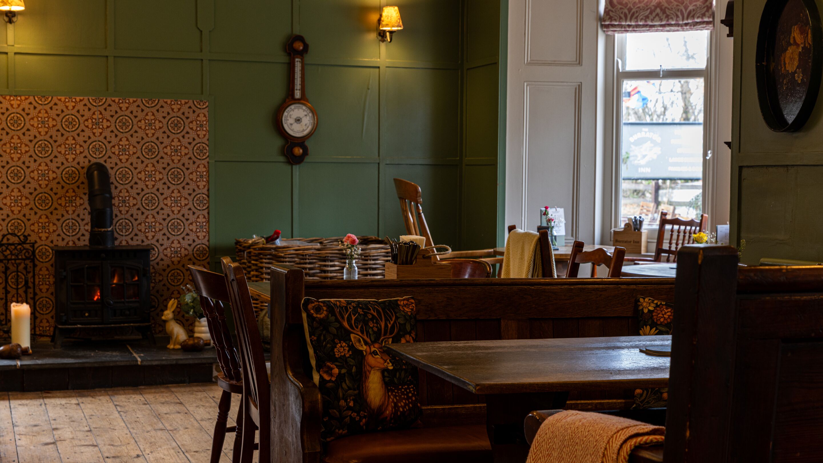 A cozy room with a fireplace, wooden furniture, and a clock on the wall.