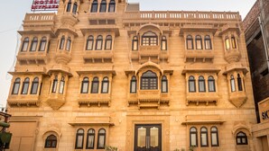 A historic building with ornate architectural details, multiple balconies, and a prominent entrance. - Hotel Sky Plaza (Jaisalmer)