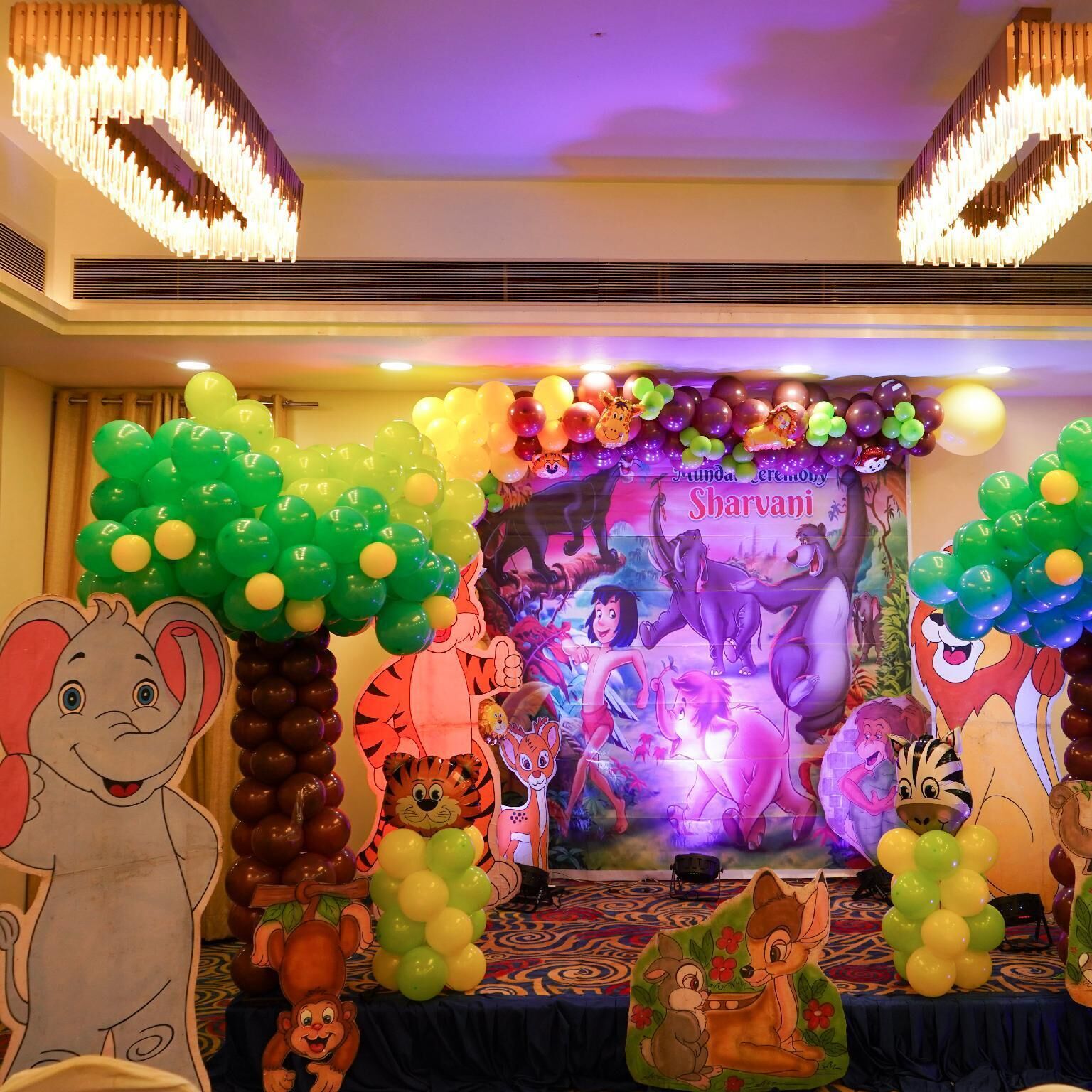 A stage with a colorful backdrop featuring cartoon characters and balloons.