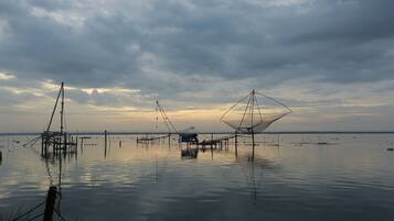 A calm water body with fishing nets and structures.
