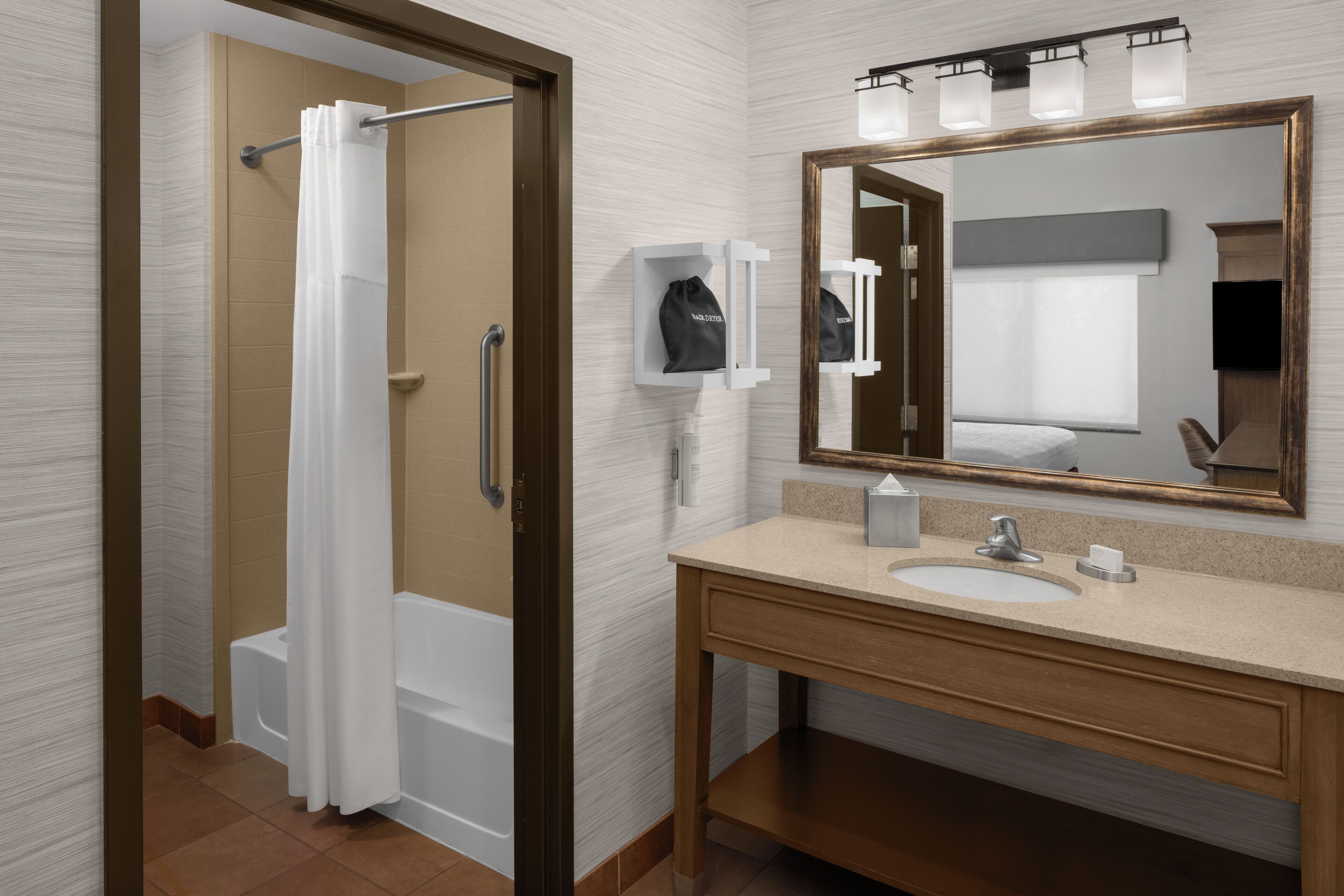 A modern bathroom with a shower, a sink, a mirror, and a towel rack.