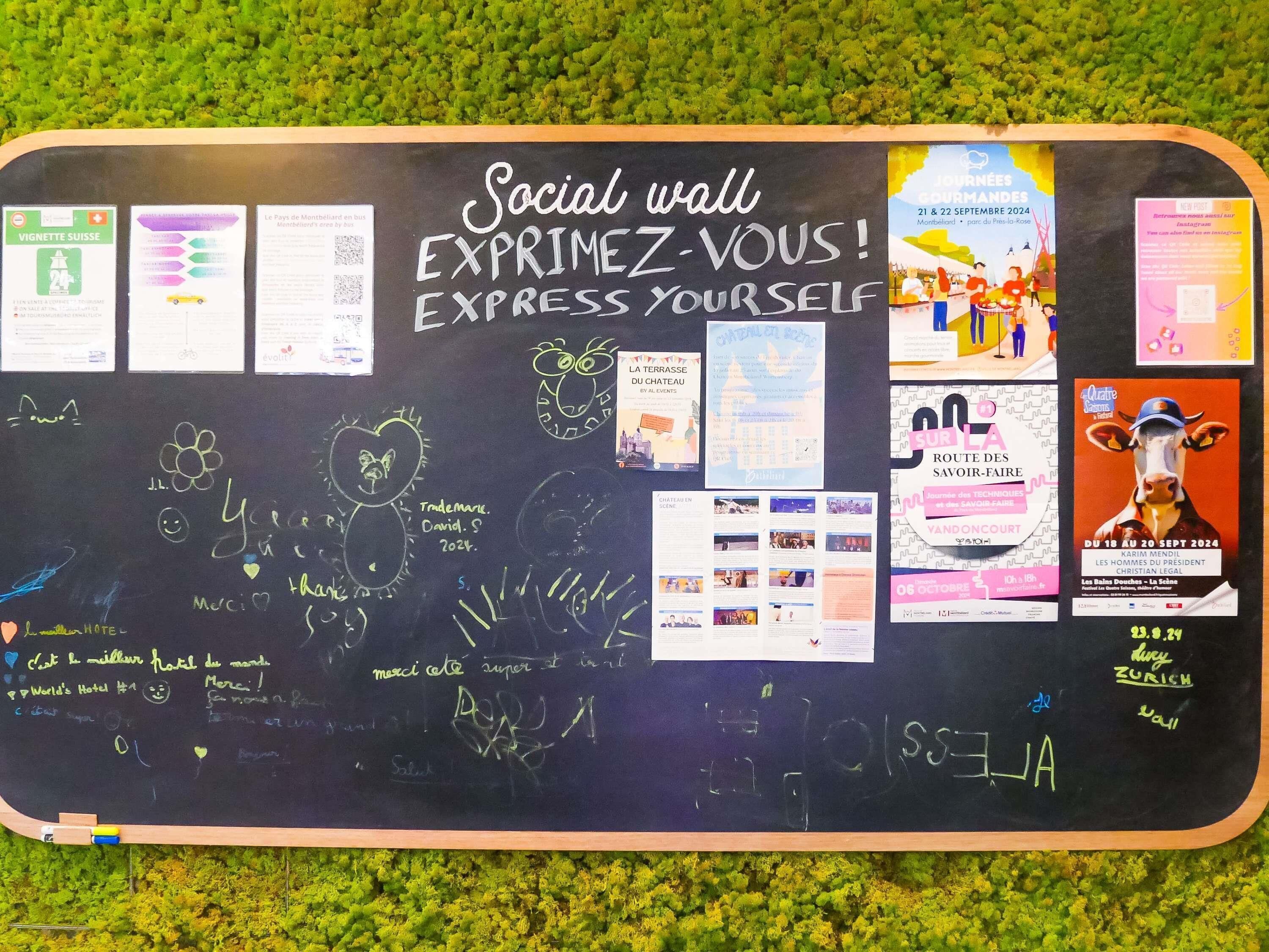 A social wall with various posters and writings, including event announcements and personal messages.