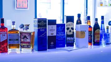A variety of liquor bottles and boxes on a counter.
