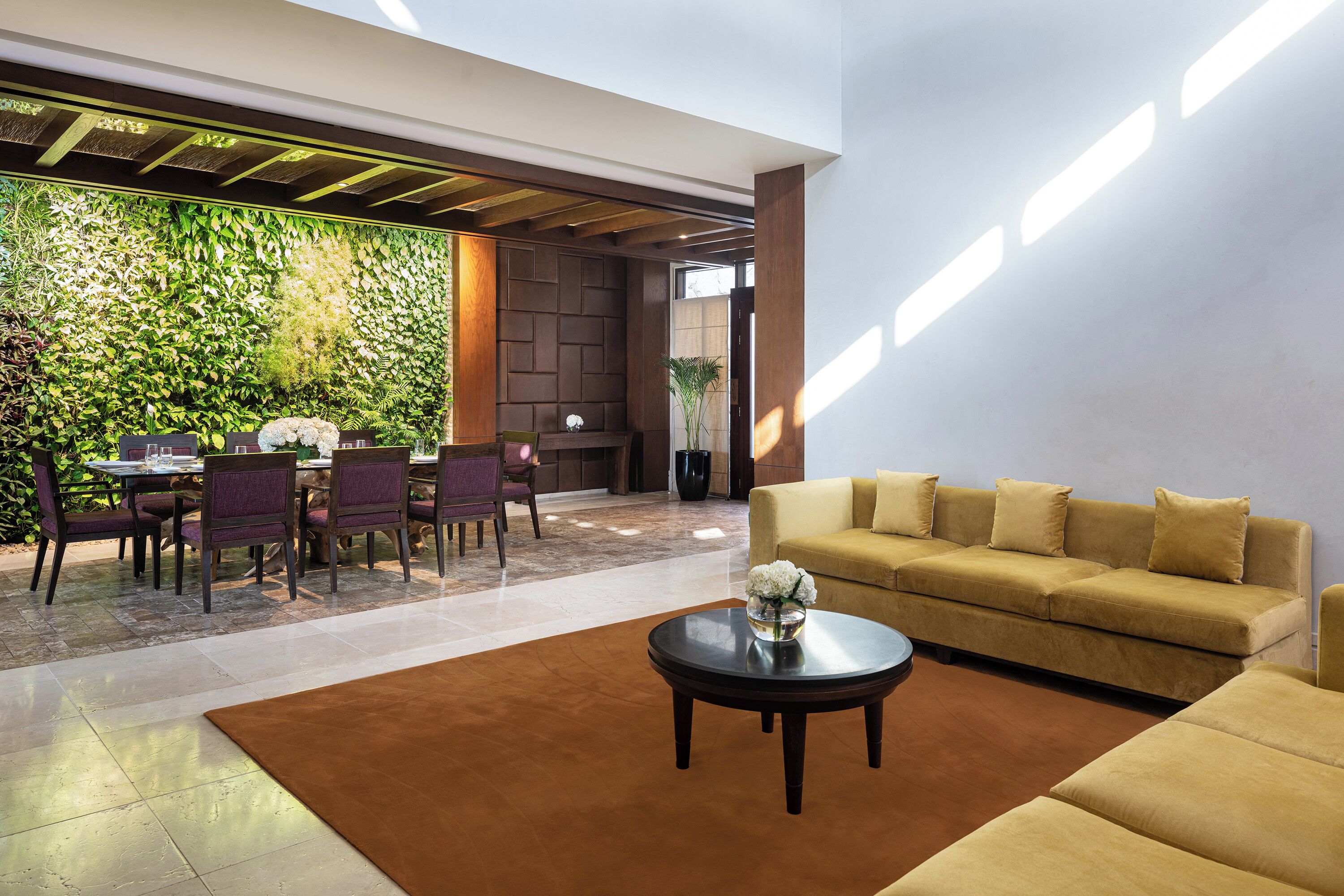 A modern interior with a dining area, a sofa, and a coffee table.
