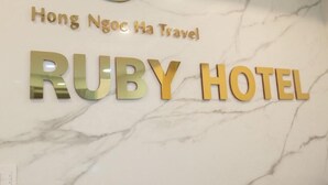 A sign for the Ruby Hotel with the name "Hong Ngoc Ha Travel" above it. - Ruby Hotel (Ho Chi Minh City)