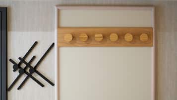 A wall with a wooden panel and a black abstract art piece.