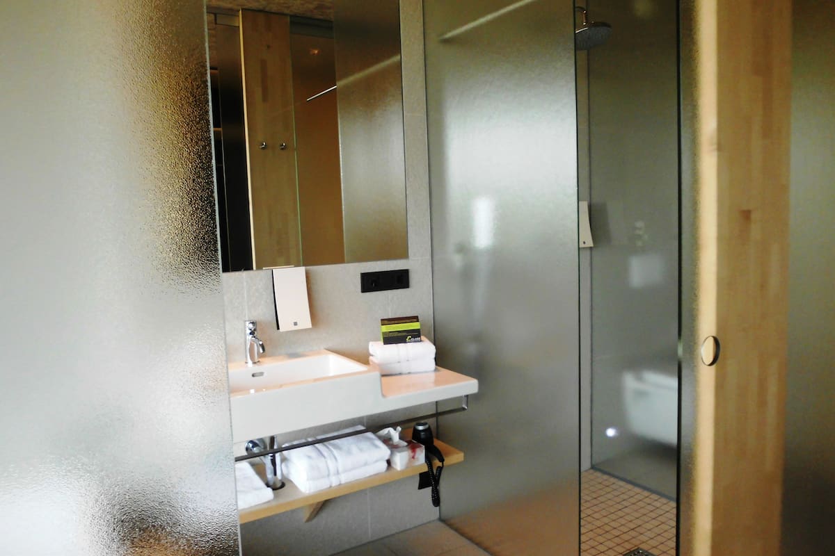 panoramic room | bathroom | rainfall showerhead, free toiletries, hair dryer, heated floors
