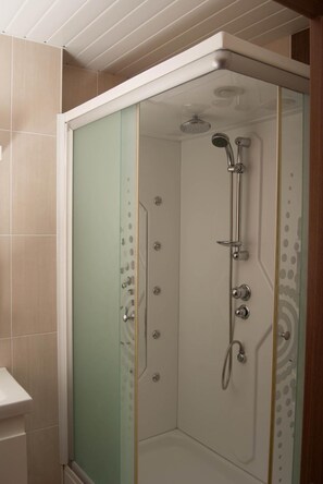 Shower, hair dryer, slippers, towels