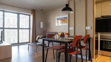Enjoy meals in the dining area with a large window and a fully equipped kitchen.