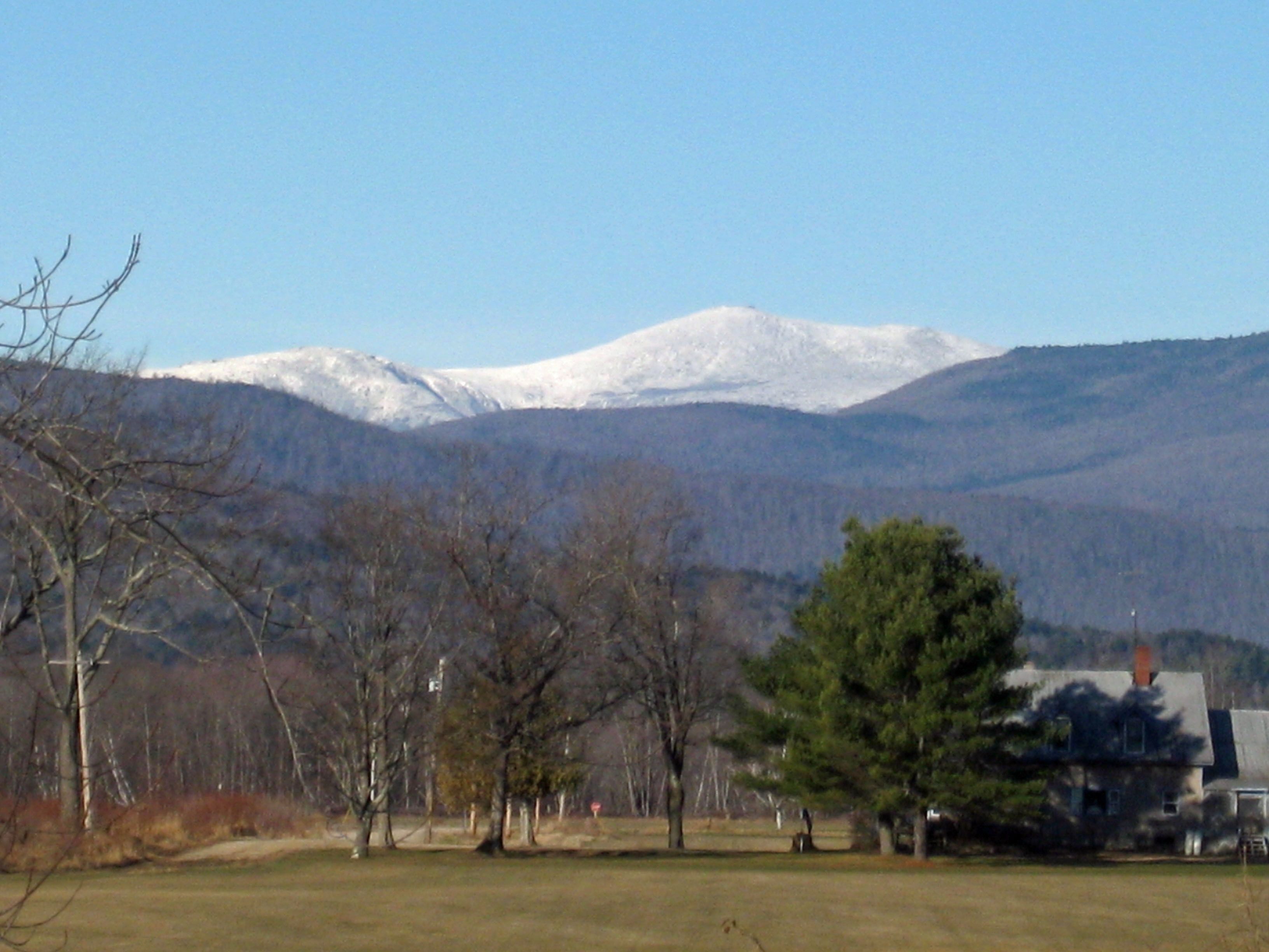 A house with a snow-covered mountain in the background.