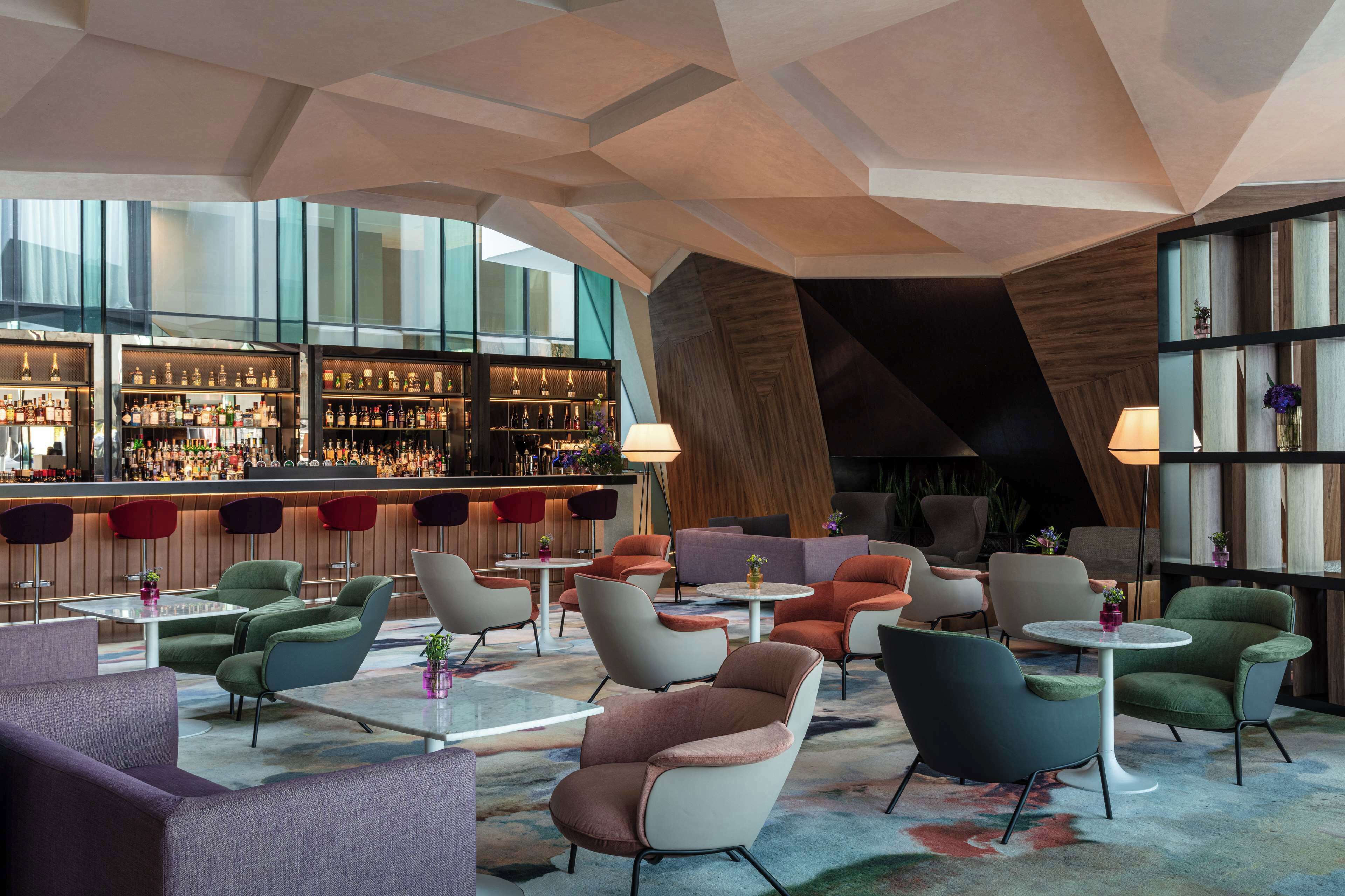 A modern bar area with seating and a large window view.