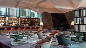 A modern bar area with seating and a large window view.