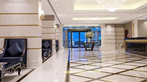 A spacious lobby with a geometric patterned floor, a grand chandelier, and a reception desk. - Rotta Hotel İstanbul (Istanbul)