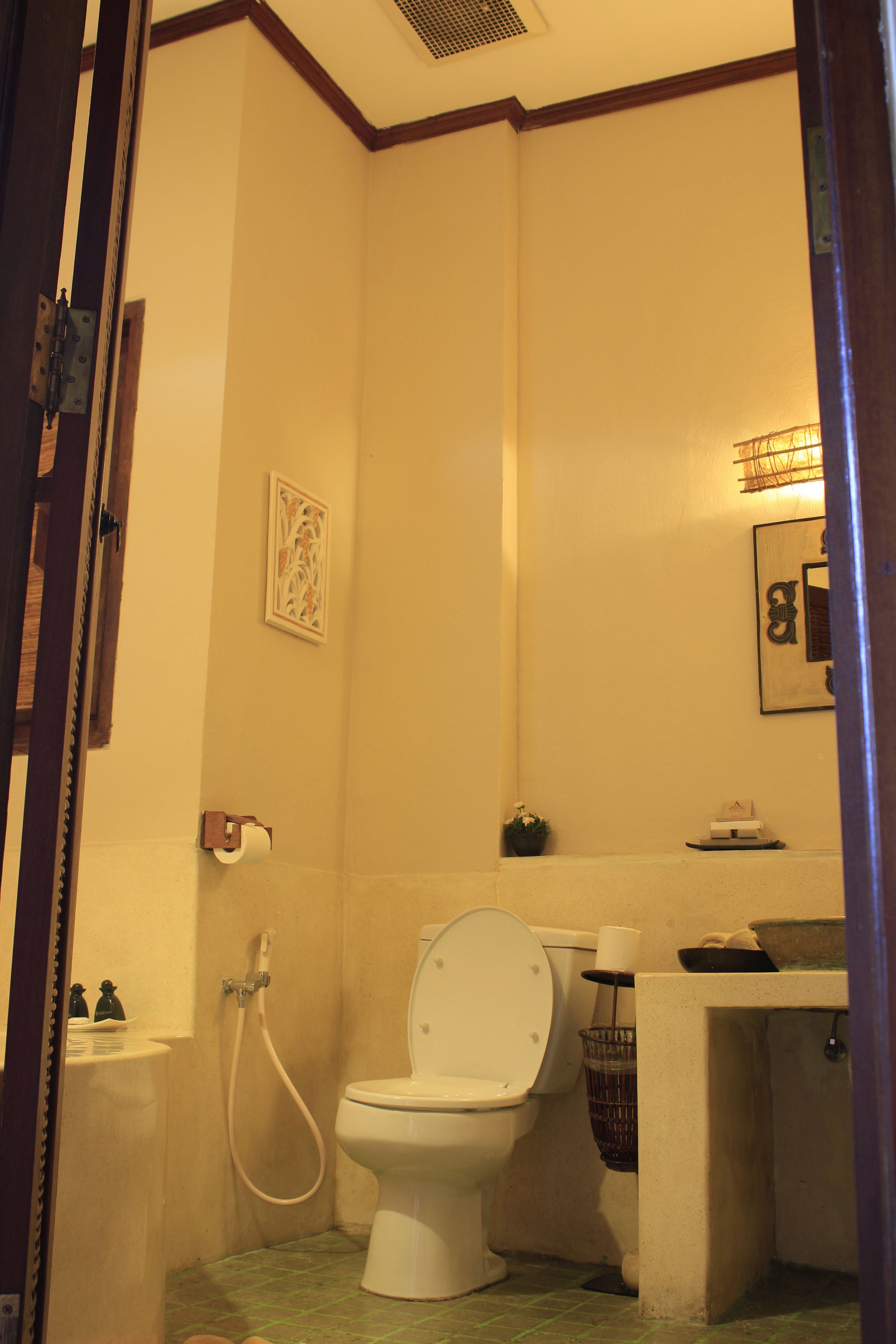 A bathroom with a toilet, a shower, and a sink.