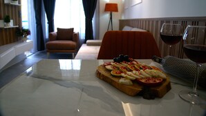 A dining table with a fruit platter and a wine glass. - Happy Apart (Kusadasi)