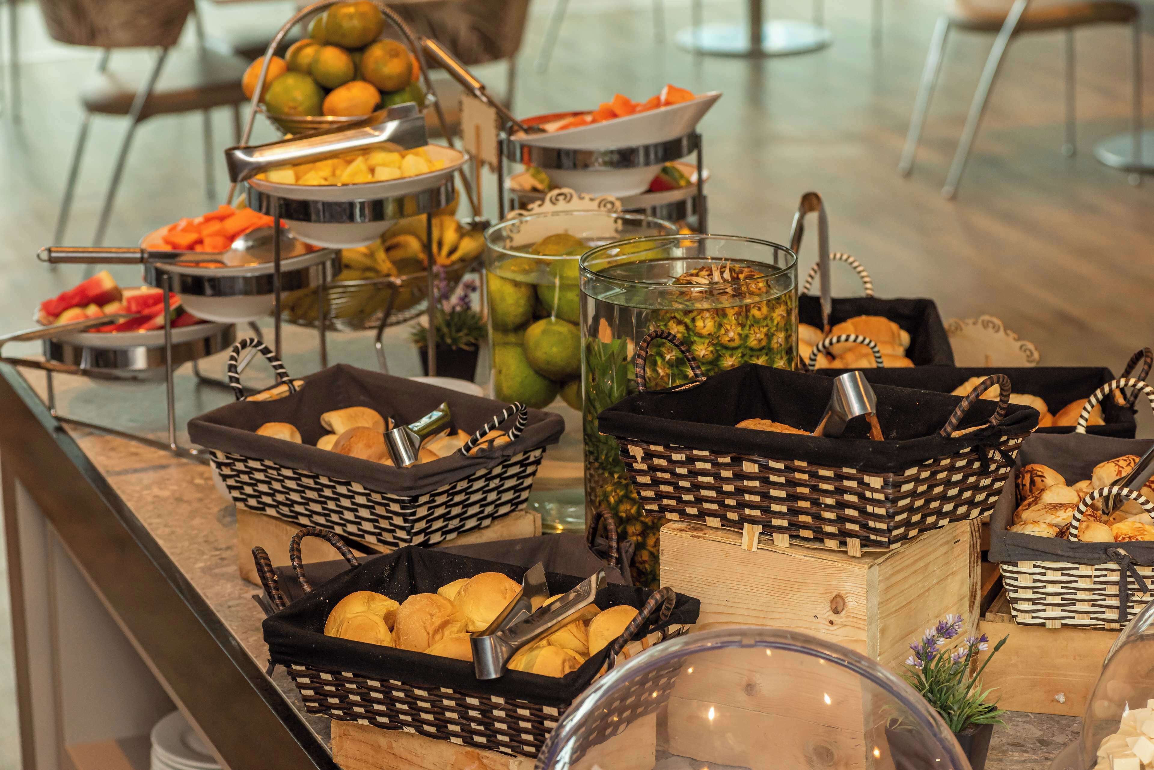 A buffet with various food items and baskets.