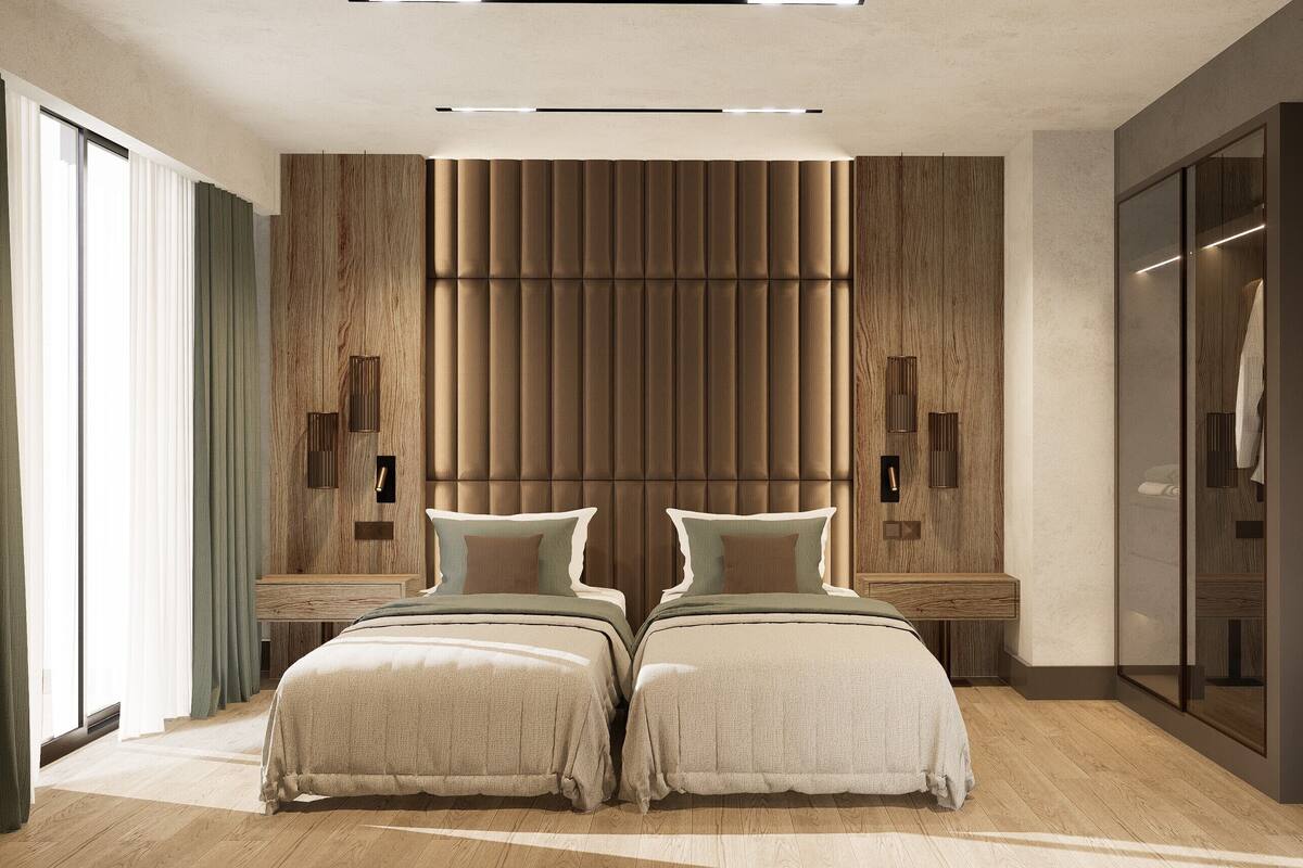 A modern bedroom with a large bed, wooden panel wall, bedside tables, and a wardrobe.