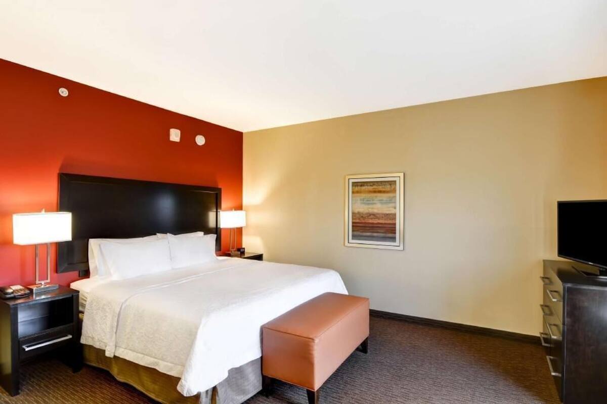 Premium bedding, desk, laptop workspace, blackout drapes