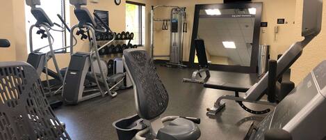 A gym with treadmills, stationary bikes, and weight machines.