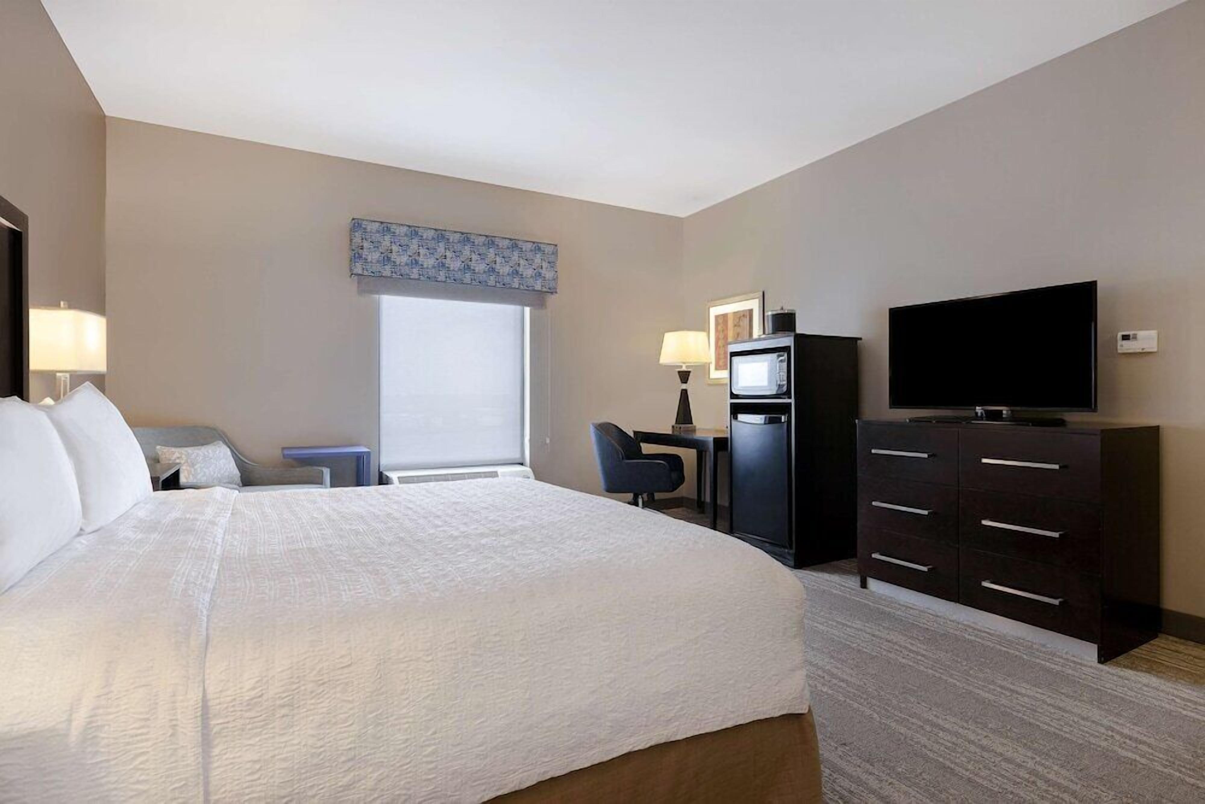 Premium bedding, desk, laptop workspace, blackout drapes