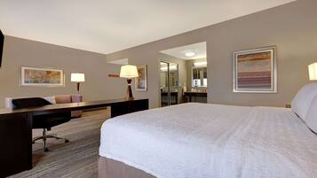 Premium bedding, desk, laptop workspace, blackout drapes