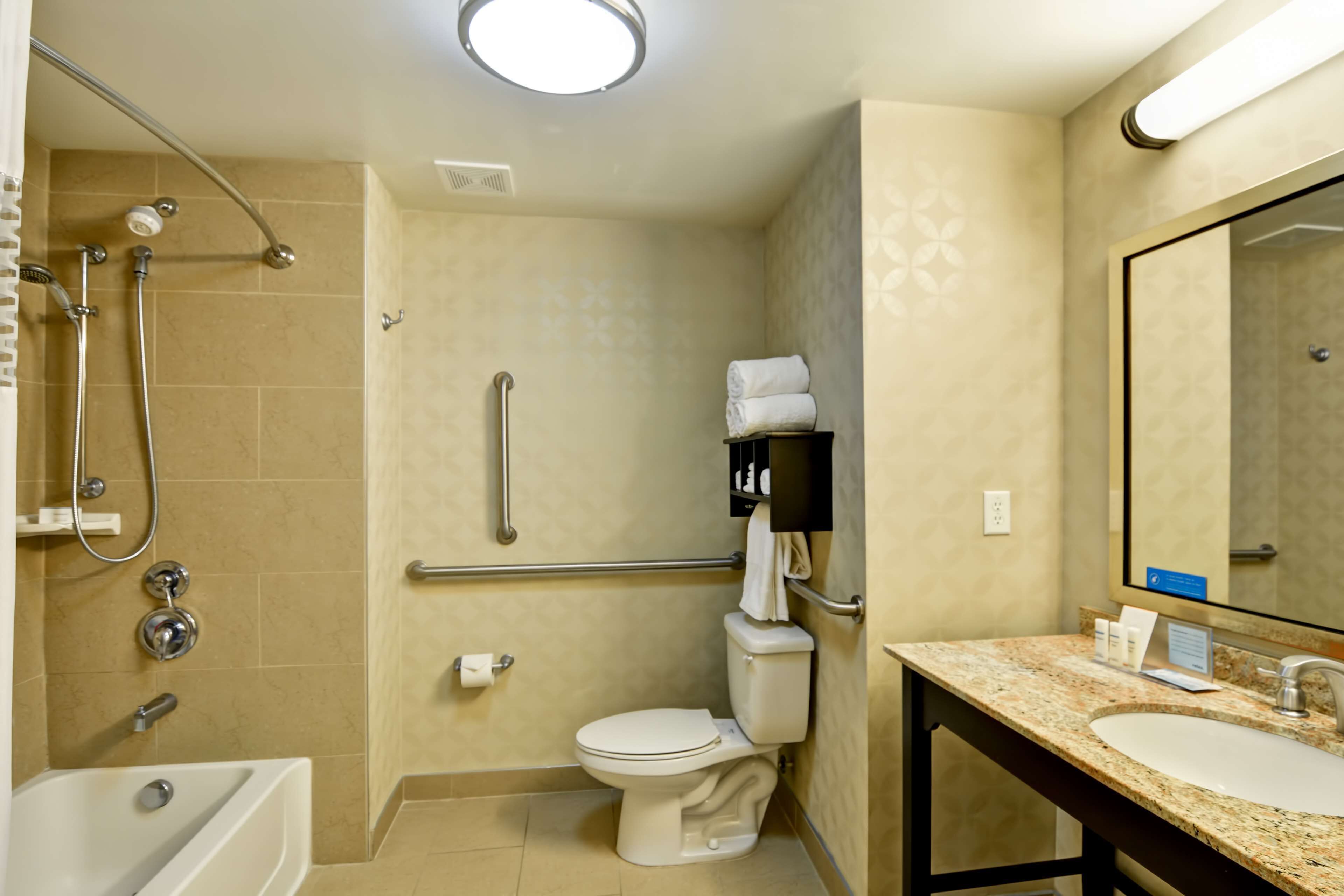 A bathroom with a bathtub, toilet, and shower.