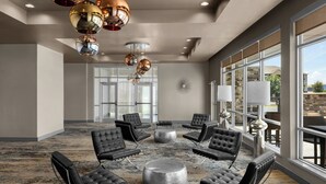 A spacious lobby with a central seating area, large windows, and a modern chandelier. - SpringHill Suites by Marriott Midland Odessa (Midland)
