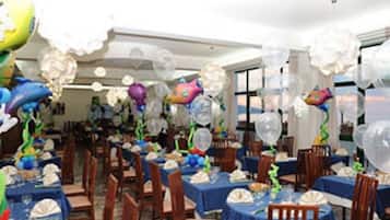 Guests can dine in style at this elegant space with tables set with blue tablecloths and white napkins.