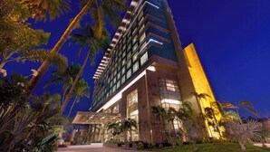 A modern hotel with a prominent vertical design, large windows, and a well-lit entrance. - The Westin Chennai Velachery (Chennai)