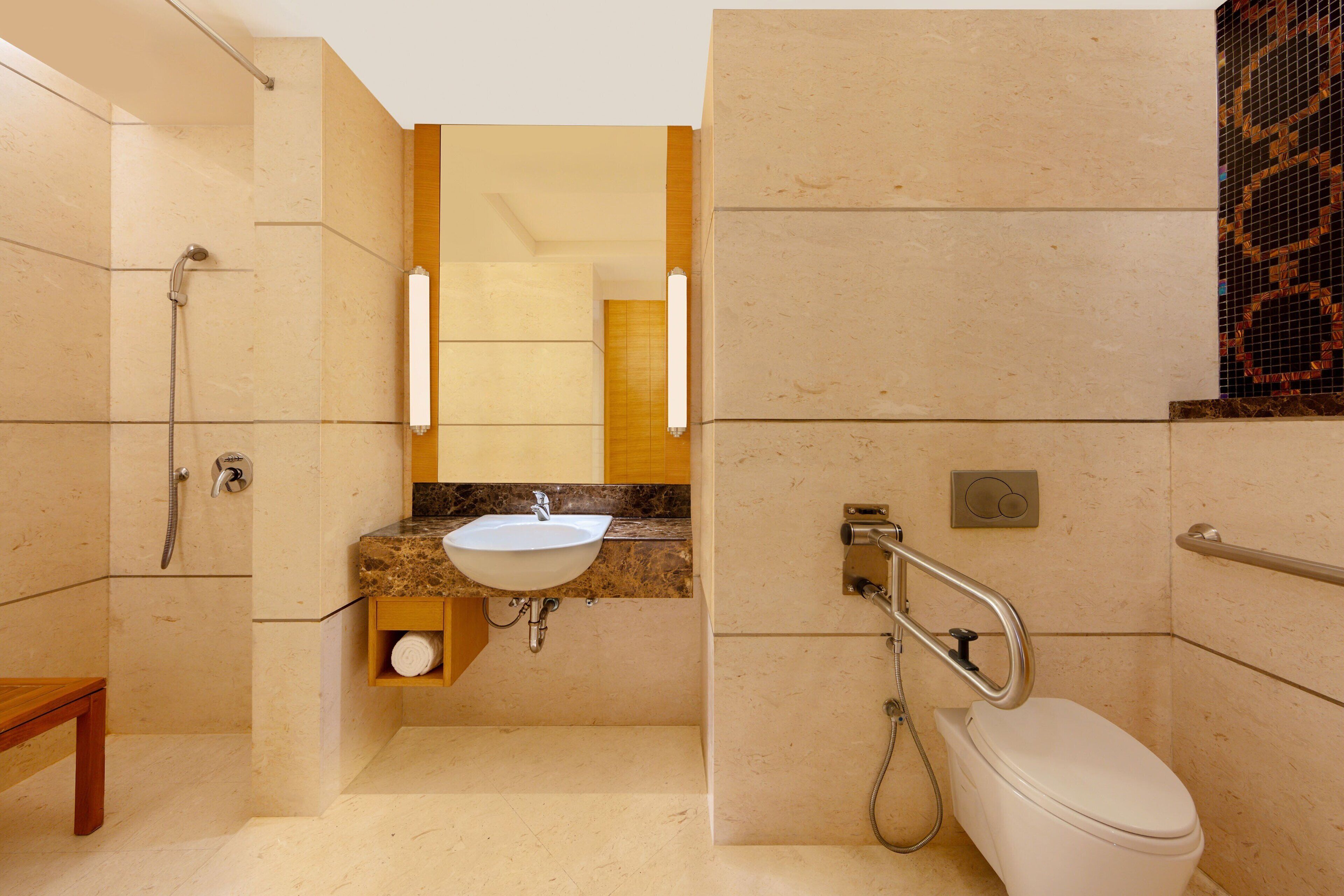 A modern bathroom with a sink, toilet, and shower.