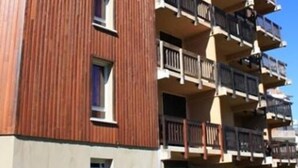 A multi-story building with balconies and a stone base. - Les Hauts Plateaux (Ax-les-Thermes)